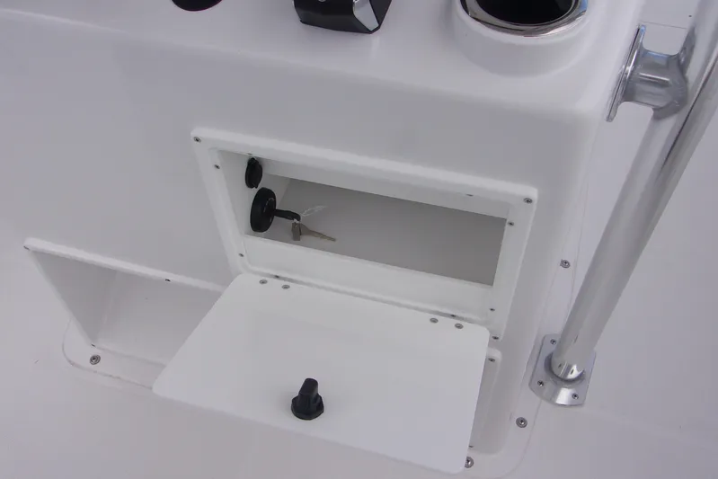  Yacht Photos Pics 2025 Bluewater 23 T boat console with open storage compartment and key.