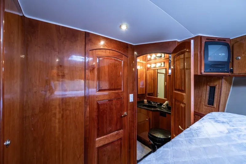 Kell Bell Yacht Photos Pics Luxurious 2001 Navigator Pilothouse yacht interior with wood paneling and compact bathroom.