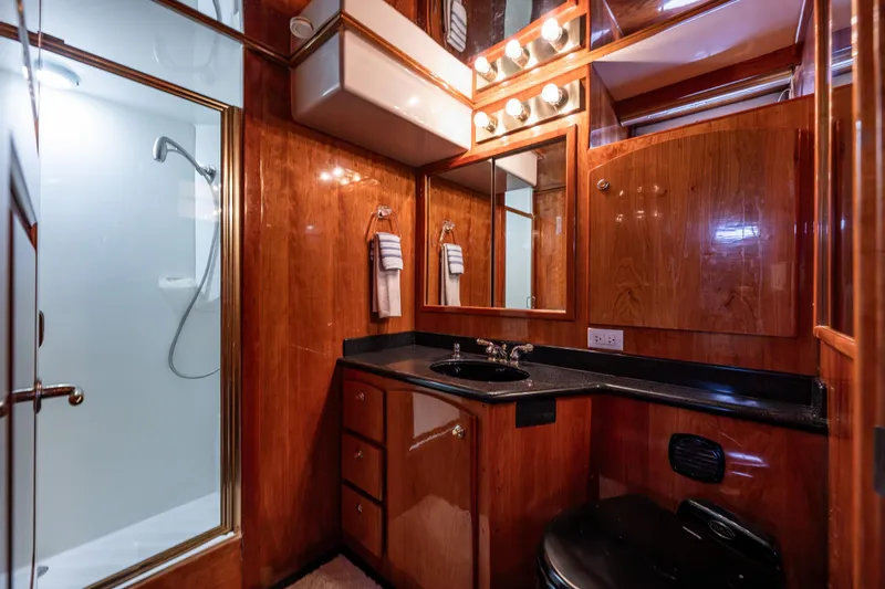 Kell Bell Yacht Photos Pics Luxurious 2001 Navigator Pilothouse bathroom with wood paneling and modern fixtures.
