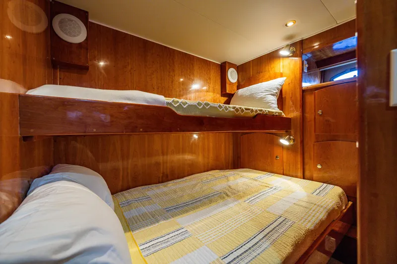 Kell Bell Yacht Photos Pics 2001 Navigator Pilothouse yacht cabin with wooden bunk beds and cozy lighting.