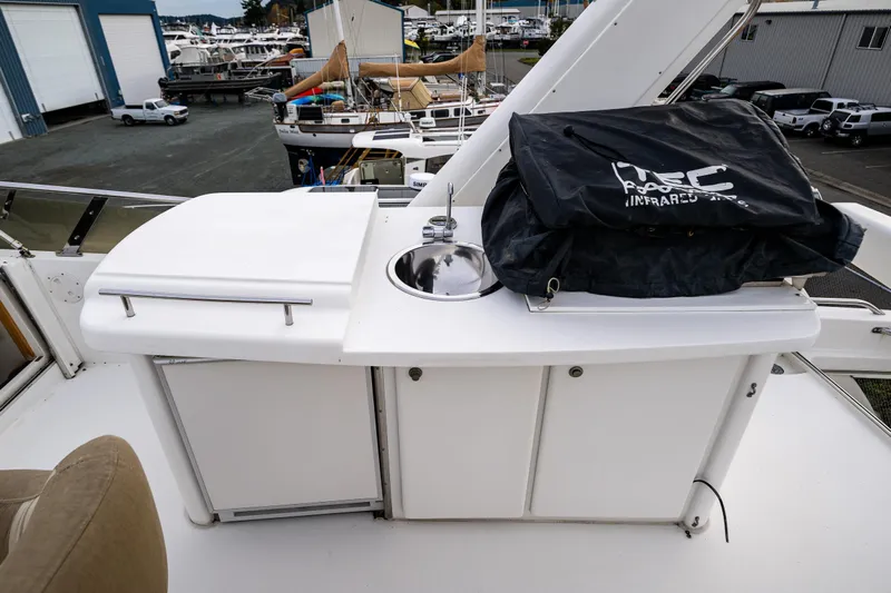 Kell Bell Yacht Photos Pics Outdoor kitchen area on 2001 Navigator Pilothouse yacht with sink and storage.