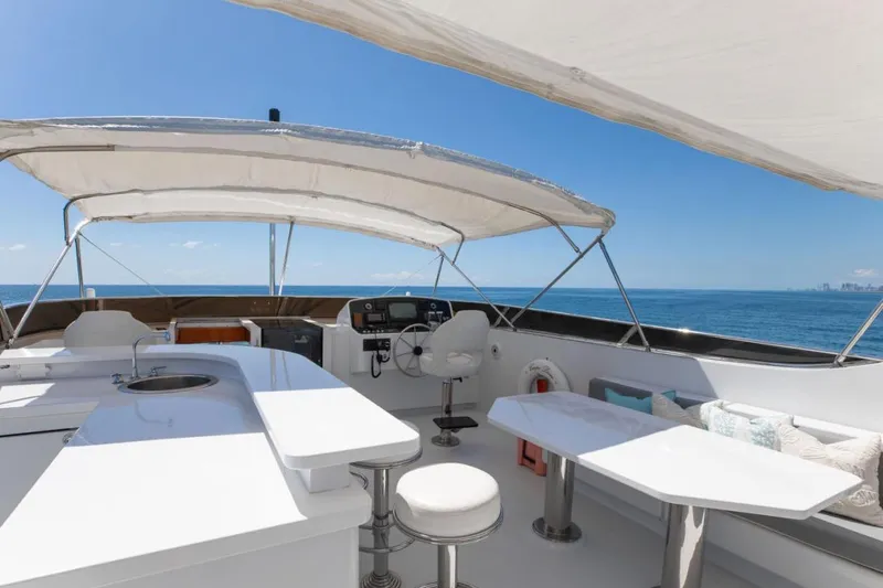 Carpe Diem Yacht Photos Pics Luxurious 2001 Intermarine RPH 95 yacht deck with seating, ocean view, and helm station.