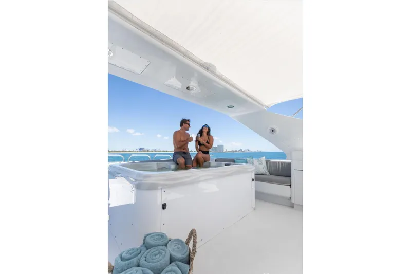 Carpe Diem Yacht Photos Pics Couple relaxing in jacuzzi on 2001 Intermarine RPH 95 yacht, ocean view, sunny day.