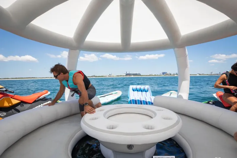 Carpe Diem Yacht Photos Pics Man enjoying water activities on inflatable boat near Intermarine RPH 95 yacht, 2001 model.