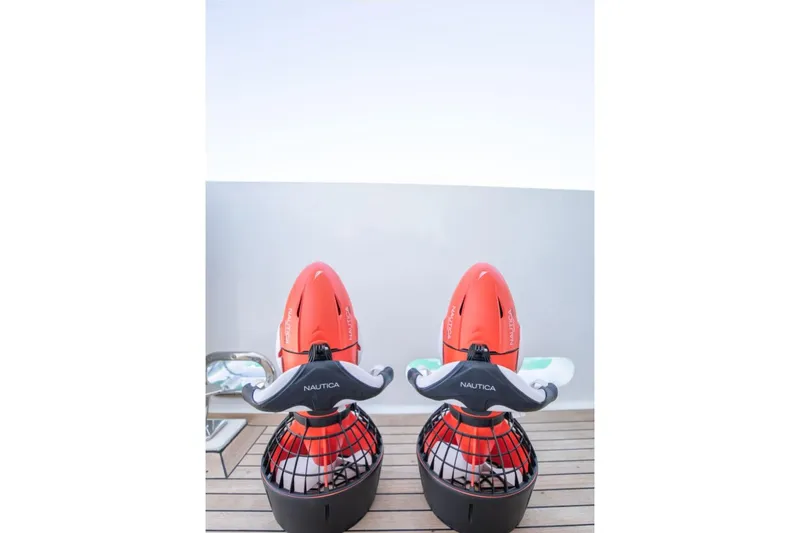 Carpe Diem Yacht Photos Pics Two red Nautica sea scooters on a wooden deck, Intermarine RPH 95 yacht, 2001 model.