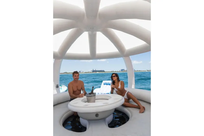 Carpe Diem Yacht Photos Pics Two people relaxing on a yacht, Intermarine RPH 95, 2001, enjoying drinks.