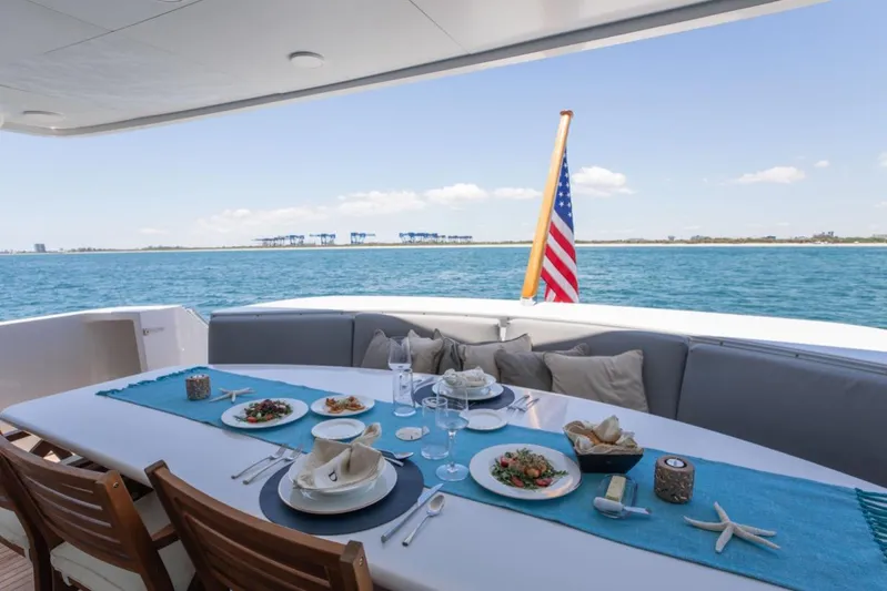 Carpe Diem Yacht Photos Pics Luxury dining setup on 2001 Intermarine RPH 95 yacht with ocean view.