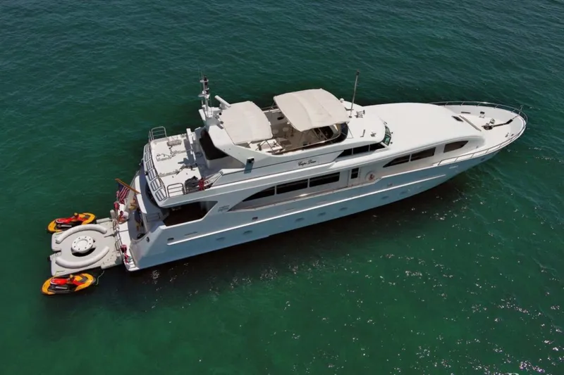 Carpe Diem Yacht Photos Pics Luxury 2001 Intermarine RPH 95 yacht on clear blue water with jet skis attached.