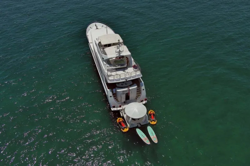 Carpe Diem Yacht Photos Pics Aerial view of 2001 Intermarine RPH 95 yacht with paddleboards and inflatables in the ocean.