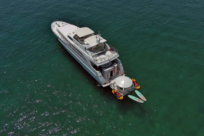 Carpe Diem Yacht Photos Pics Aerial view of 2001 Intermarine RPH 95 yacht with paddleboards and inflatables in the ocean.