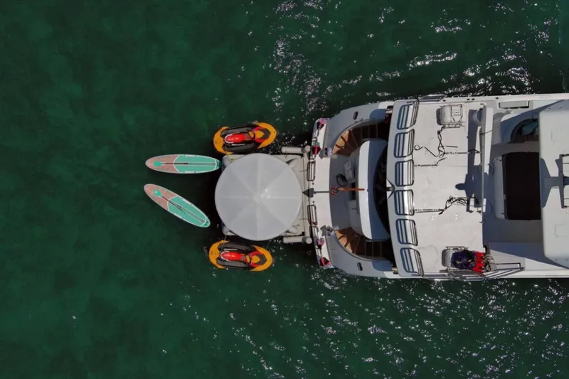 Carpe Diem Yacht Photos Pics Aerial view of 2001 Intermarine RPH 95 yacht with paddleboards and jet skis.