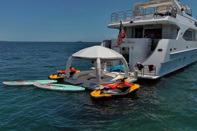 Carpe Diem Yacht Photos Pics Luxury yacht Intermarine RPH 95 with jet skis and paddleboards on the ocean, 2001 model.