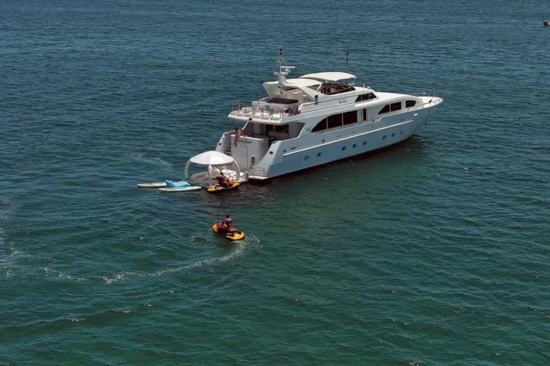 Carpe Diem Yacht Photos Pics Luxury yacht Intermarine RPH 95, 2001 model, anchored with jet skis nearby.