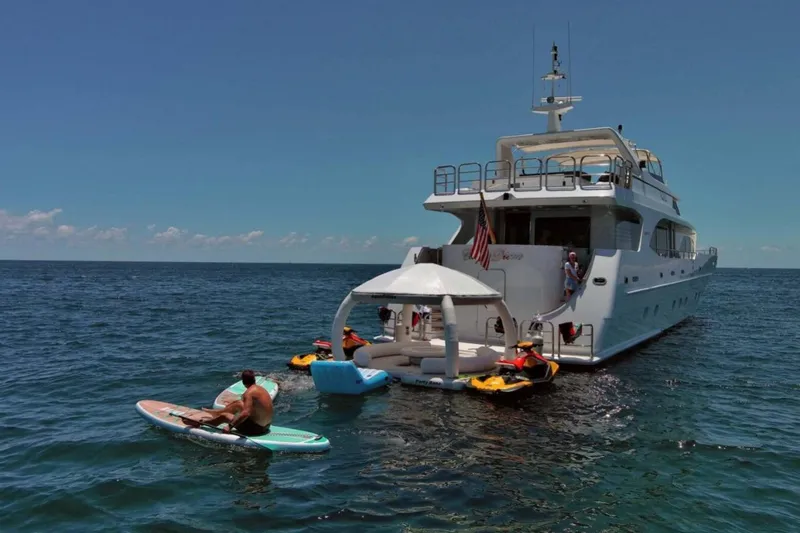 Carpe Diem Yacht Photos Pics Luxury yacht Intermarine RPH 95, 2001 model, with people enjoying water activities nearby.