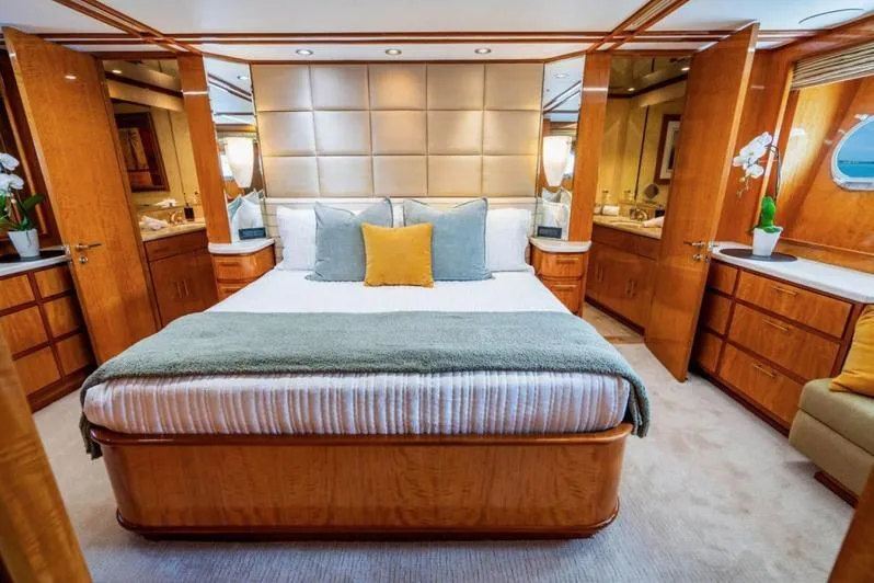 Carpe Diem Yacht Photos Pics Luxurious bedroom interior of 2001 Intermarine RPH 95 yacht with elegant wood finishes.