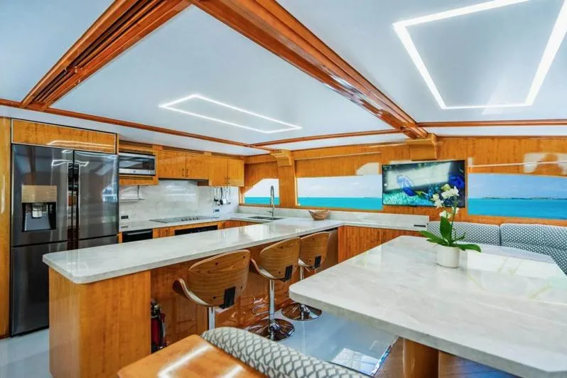 Carpe Diem Yacht Photos Pics Luxurious kitchen interior of 2001 Intermarine RPH 95 yacht with modern design and wooden accents.