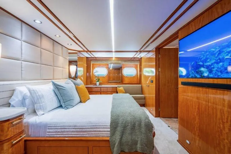 Carpe Diem Yacht Photos Pics Luxurious bedroom interior of 2001 Intermarine RPH 95 yacht with elegant wood finishes.