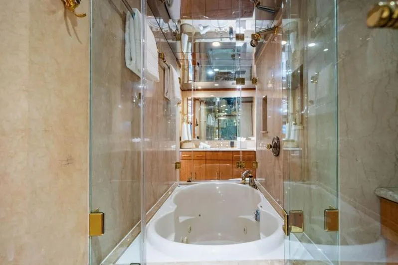 Carpe Diem Yacht Photos Pics Luxurious bathroom with a glass-enclosed bathtub on the 2001 Intermarine RPH 95 yacht.