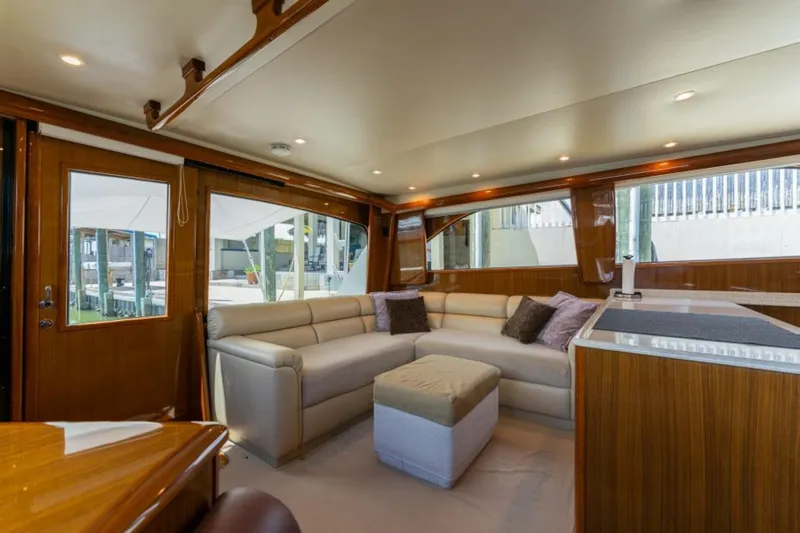 Kraken Yacht Photos Pics Luxurious interior of 2007 Viking 52 Convertible yacht with plush seating and elegant wood finishes.