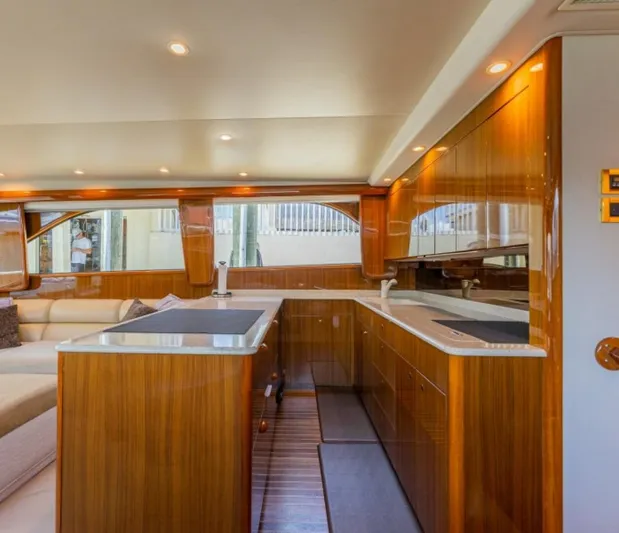 Kraken Yacht Photos Pics Luxurious interior of 2007 Viking 52 Convertible yacht with polished wood finishes.