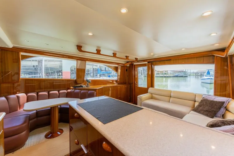 Kraken Yacht Photos Pics Luxurious interior of a 2007 Viking 52 Convertible yacht with elegant seating and large windows.