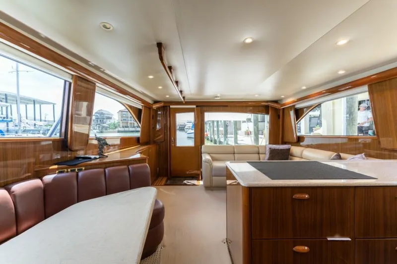 Kraken Yacht Photos Pics Luxurious interior of 2007 Viking 52 Convertible yacht with elegant wood finishes and spacious seating.