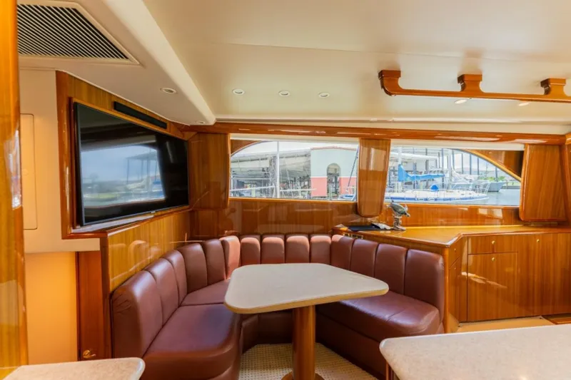 Kraken Yacht Photos Pics Luxurious interior of 2007 Viking 52 Convertible yacht with leather seating and large windows.