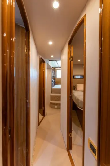 Kraken Yacht Photos Pics Interior hallway of 2007 Viking 52 Convertible yacht with wooden doors and soft lighting.