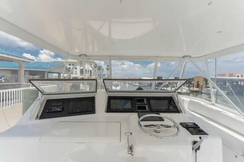 Kraken Yacht Photos Pics 2007 Viking 52 Convertible yacht helm with steering wheel and navigation controls.