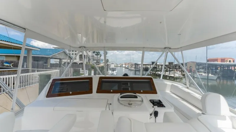 Kraken Yacht Photos Pics 2007 Viking 52 Convertible yacht helm with marina view, featuring modern navigation equipment.