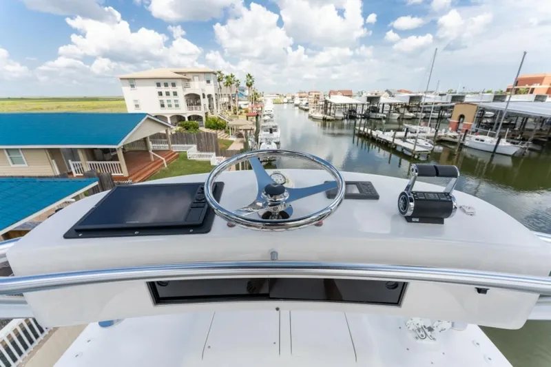 Kraken Yacht Photos Pics 2007 Viking 52 Convertible yacht helm with marina view, featuring steering wheel and controls.