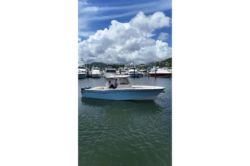  Yacht Photos Pics 2019 Grady-White Canyon 306 boat in a marina under a cloudy sky.
