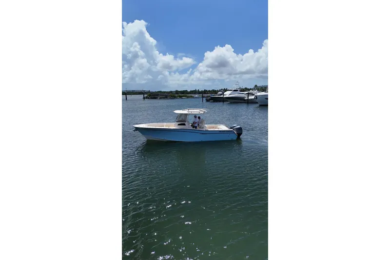  Yacht Photos Pics 2019 Grady-White Canyon 306 boat on calm water under blue sky.