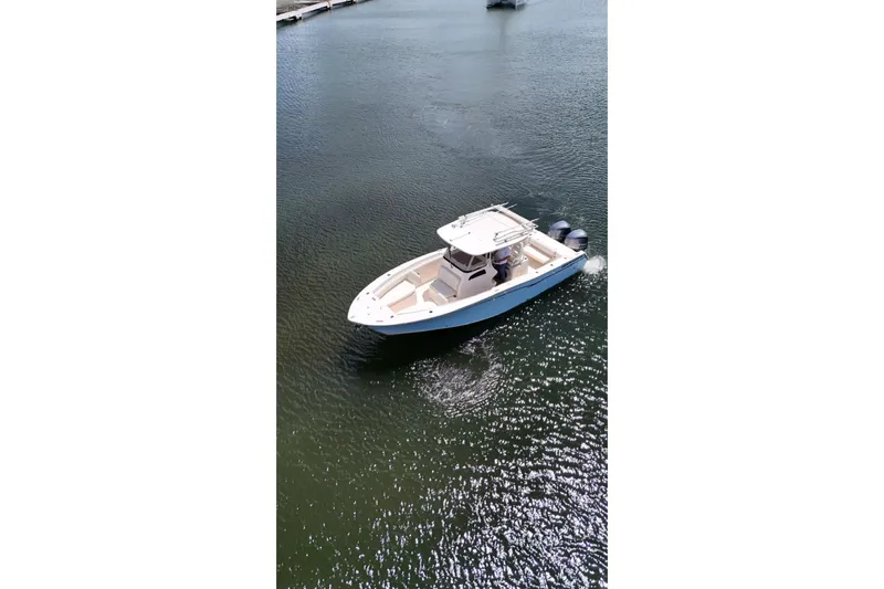  Yacht Photos Pics 2019 Grady-White Canyon 306 boat cruising on calm water.