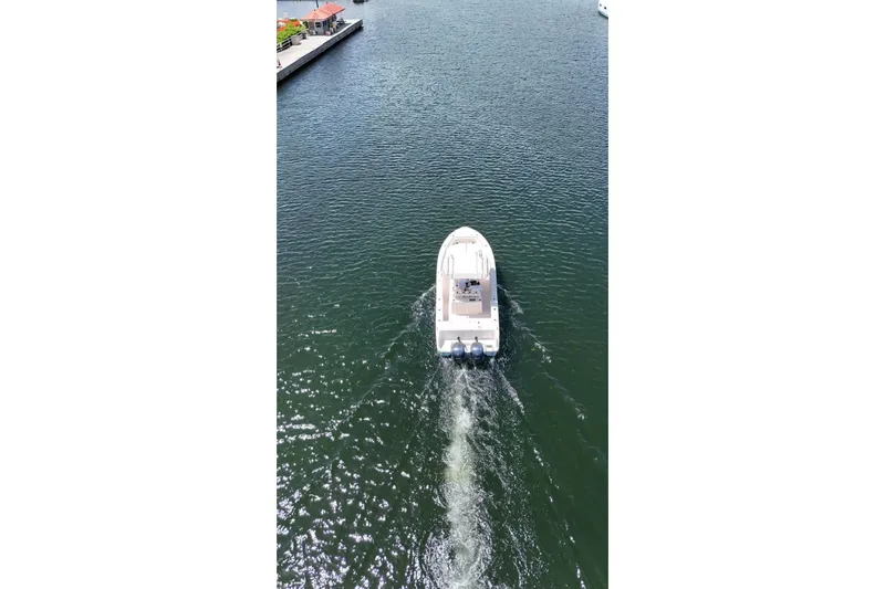  Yacht Photos Pics 2019 Grady-White Canyon 306 boat cruising on a calm waterway.