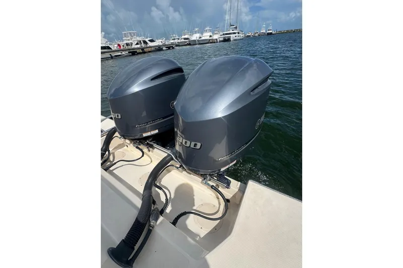  Yacht Photos Pics Twin outboard engines on a 2019 Grady-White Canyon 306 boat at a marina.