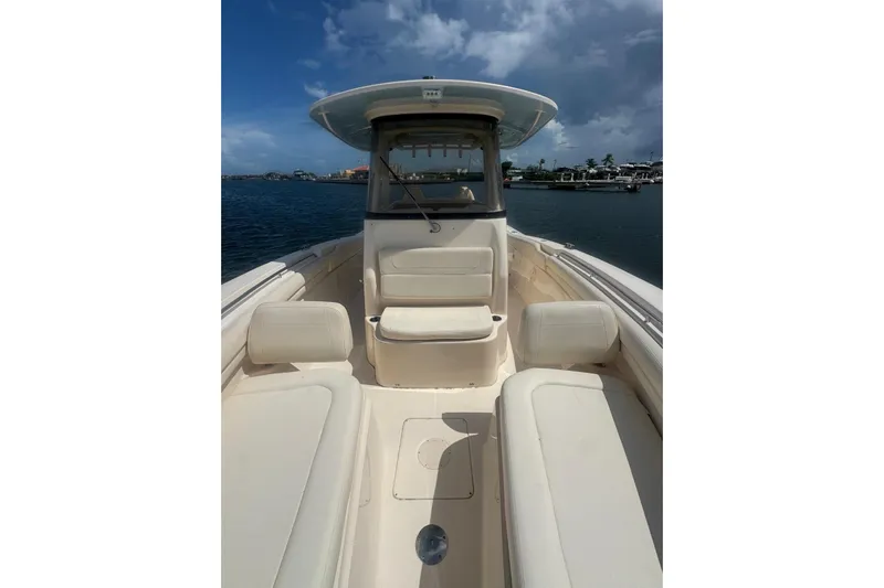  Yacht Photos Pics 2019 Grady-White Canyon 306 boat interior with seating, under a cloudy sky.
