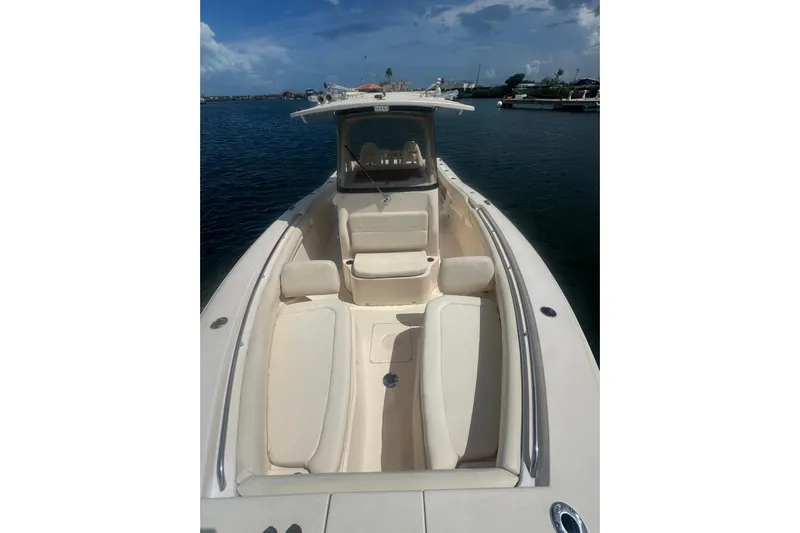  Yacht Photos Pics 2019 Grady-White Canyon 306 boat with spacious seating, docked on calm waters.