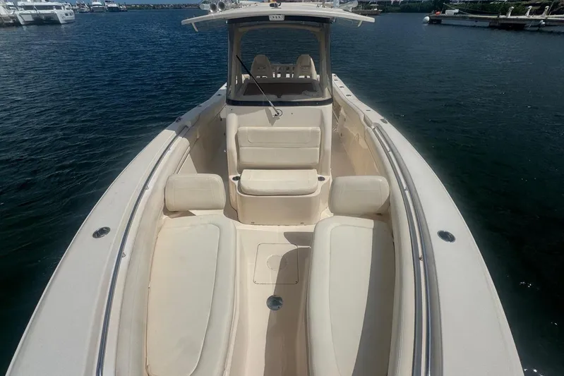  Yacht Photos Pics 2019 Grady-White Canyon 306 boat with spacious seating on calm water.