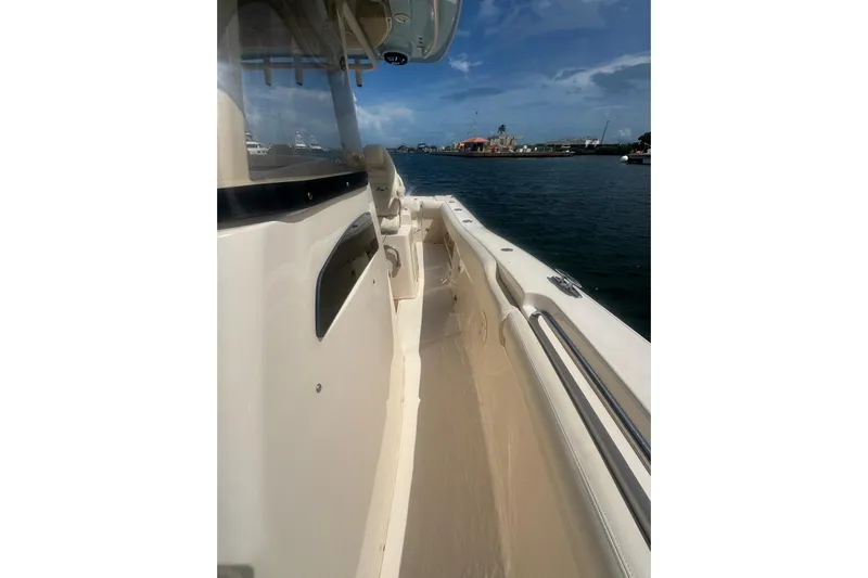  Yacht Photos Pics 2019 Grady-White Canyon 306 boat on water, showcasing sleek design and spacious deck.