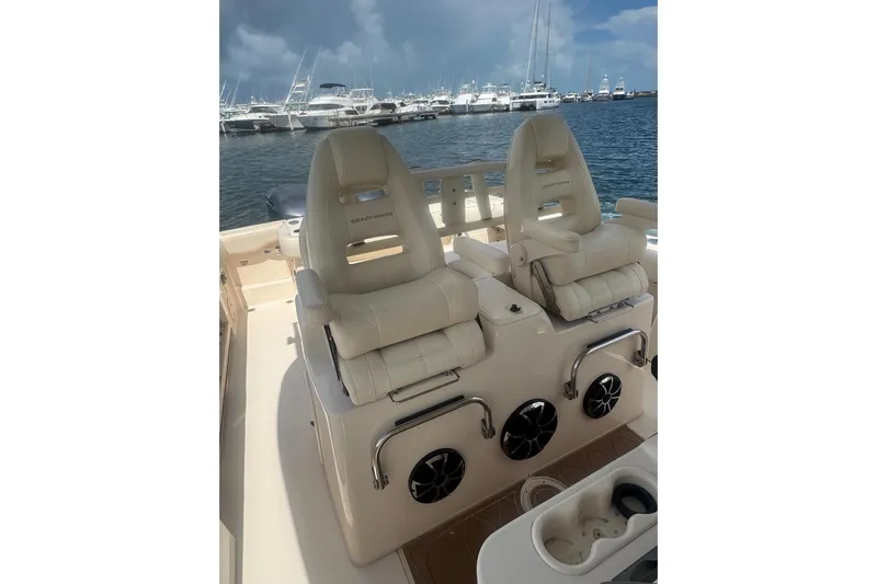  Yacht Photos Pics 2019 Grady-White Canyon 306 boat interior with dual captain's chairs, docked at marina.