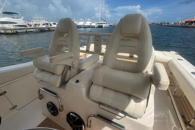  Yacht Photos Pics 2019 Grady-White Canyon 306 boat seats, docked with other boats in the background.