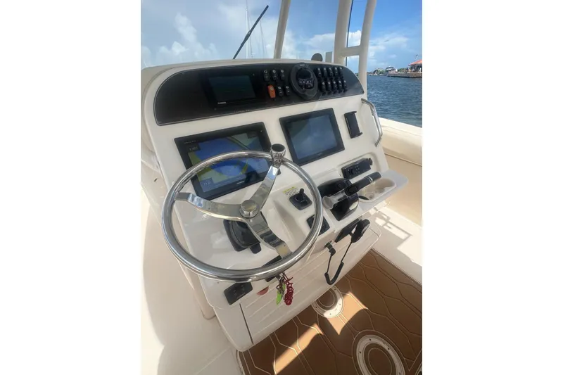  Yacht Photos Pics 2019 Grady-White Canyon 306 boat dashboard with steering wheel and navigation screens.