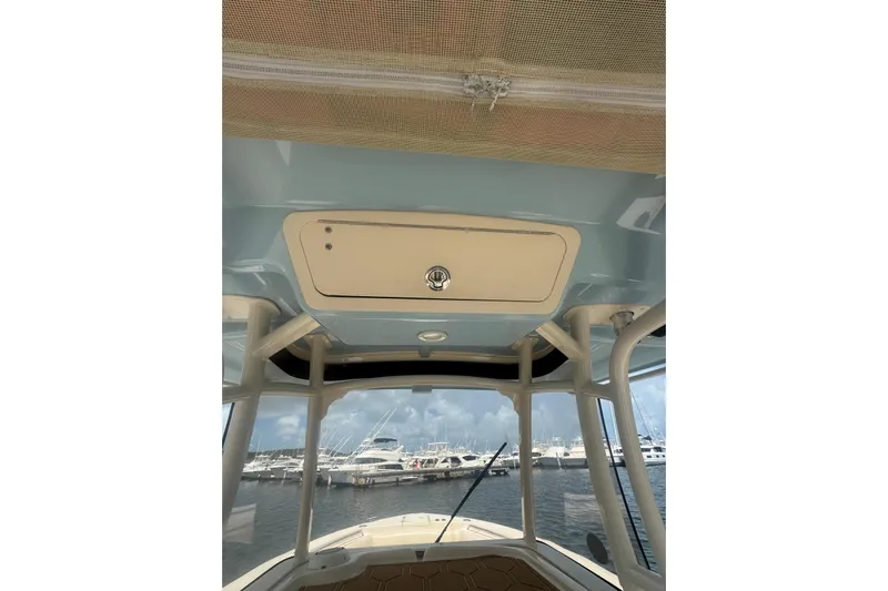  Yacht Photos Pics 2019 Grady-White Canyon 306 boat interior with overhead storage, docked at marina.
