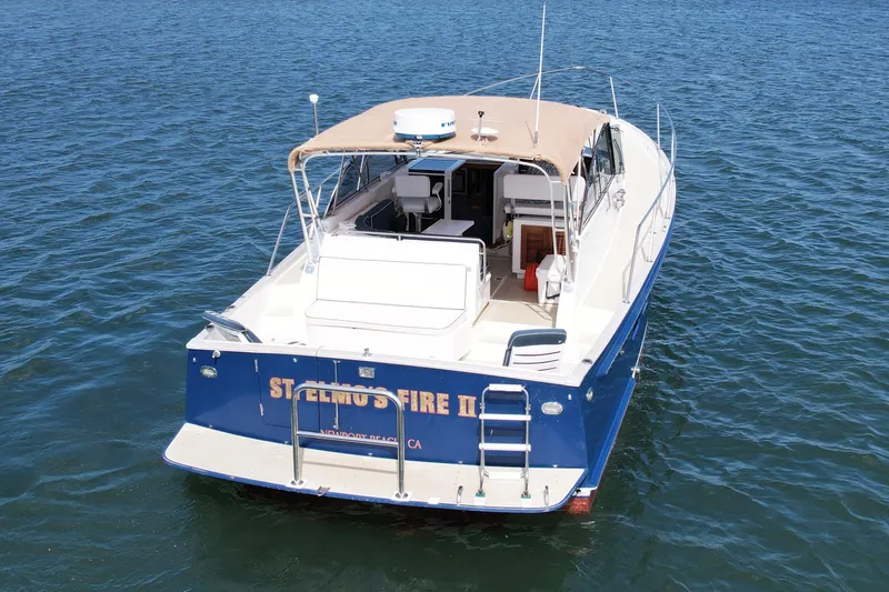 St. Elmo's Fire II Yacht Photos Pics 1999 Legacy 40 boat on water, rear view with canopy and ladder.
