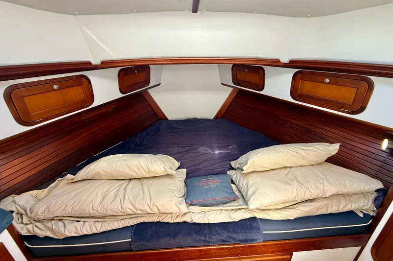 St. Elmo's Fire II Yacht Photos Pics Cozy cabin interior of 1999 Legacy 40 yacht with wooden accents and comfortable bedding.