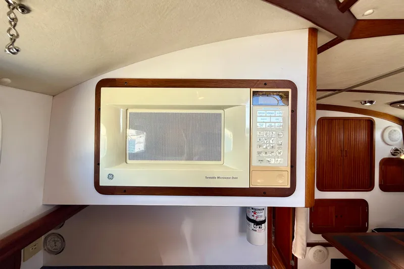 St. Elmo's Fire II Yacht Photos Pics Built-in microwave in a 1999 Legacy 40 yacht interior, featuring wood accents.