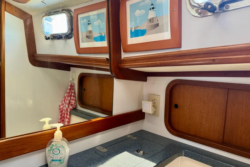 St. Elmo's Fire II Yacht Photos Pics Bathroom interior of 1999 Legacy 40 boat with mirror, artwork, and hand soap.
