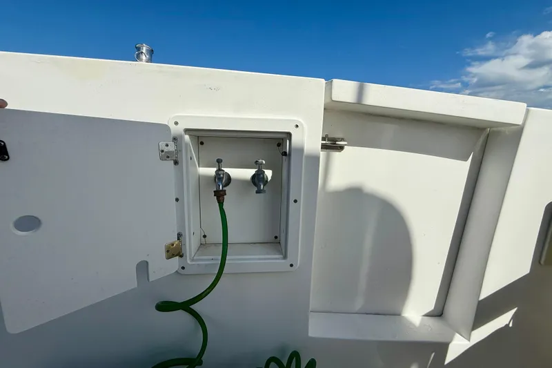 St. Elmo's Fire II Yacht Photos Pics Boat deck with open hatch and green hose, Legacy 40, 1999 model.