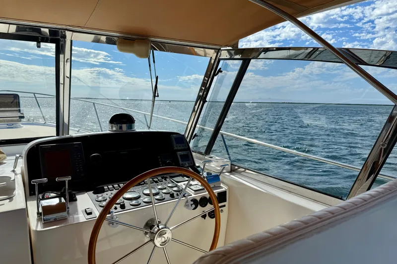 St. Elmo's Fire II Yacht Photos Pics Helm of 1999 Legacy 40 yacht with ocean view and clear sky.